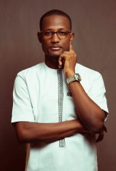 A Man in White Shirt Wearing Eyeglasses with His Hand on His Face